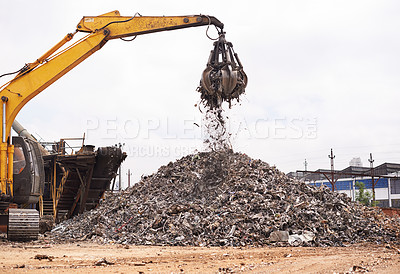 Buy stock photo Cropped shot of an excavator sorting through a pile of scrap metal