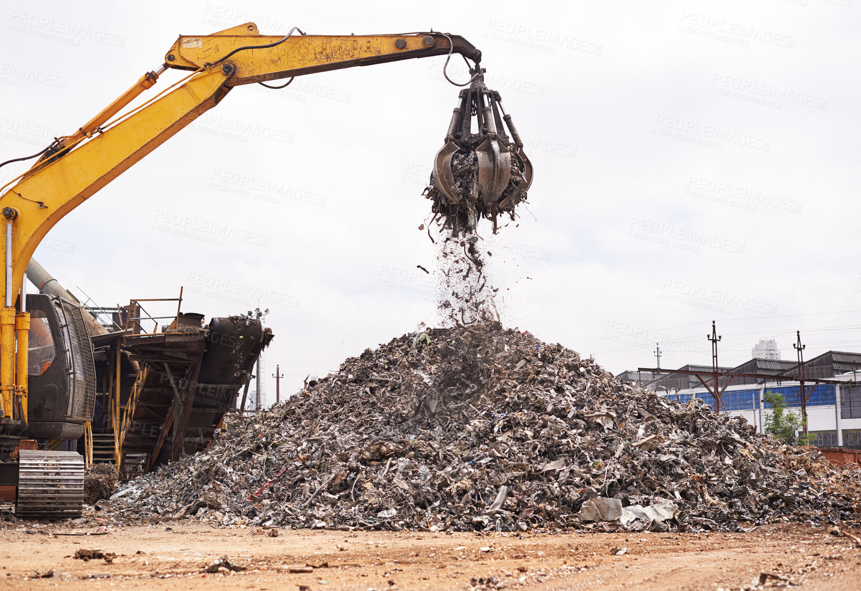 Buy stock photo Cropped shot of an excavator sorting through a pile of scrap metal