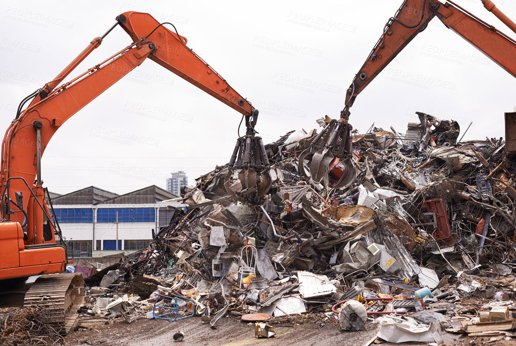 Buy stock photo Cropped shot of two excavators sorting through a pile of scrap metal