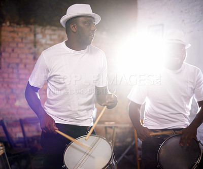 Buy stock photo Man, drums and band playing with instrument at festival, carnival or party together with lens flare. Male person, talented drummer or young group of musicians at night concert or music event in Rio