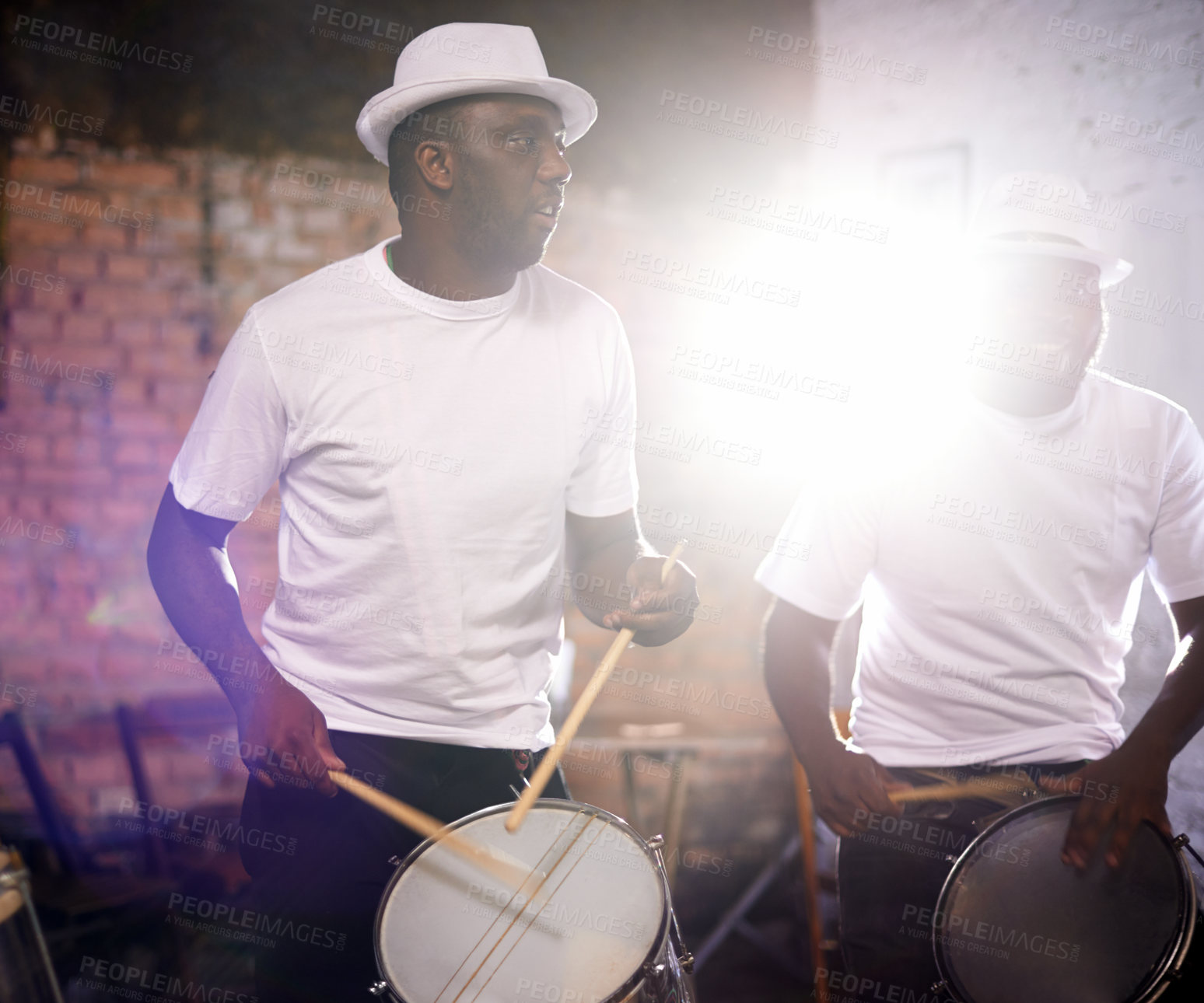 Buy stock photo Man, drums and band playing with instrument at festival, carnival or party together with lens flare. Male person, talented drummer or young group of musicians at night concert or music event in Rio