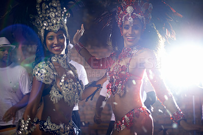 Buy stock photo Portrait, women or dancer with band at carnival in rio de janeiro for brazilian festival with feather costume or smile. People, face or night and dancing, fashion or light for culture or outdoor show