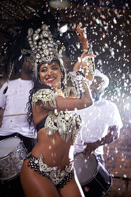 Buy stock photo Carnival, woman and dancing in street with confetti and performance in Brazil, costume and feather head gear outdoor. Music, samba and happy for event, culture with festival entertainment and talent