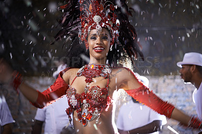 Buy stock photo Cropped shot of a beautiful samba dancer performing in a carnival with her band