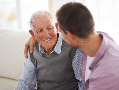 Buy stock photo Shot of a senior father bonding with his son in their living room