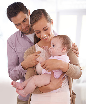Buy stock photo Mother, father and baby with happiness in home for healthy development, security and comfort in apartment. Family, man and woman with infant, smile and embrace for parenting, bonding or love in house