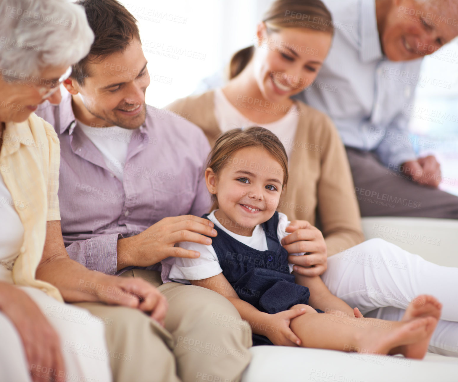 Buy stock photo Portrait, big family and happy kid on sofa in home for bonding, love or child relax together with parents. Face, grandparents and girl with mother and father in living room with smile for connection