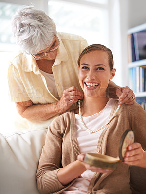 Buy stock photo Elderly mother, necklace and portrait of woman with present, gift and surprise in living room. Family, love and happy daughter with mom giving pearls on sofa for celebration, birthday and bonding