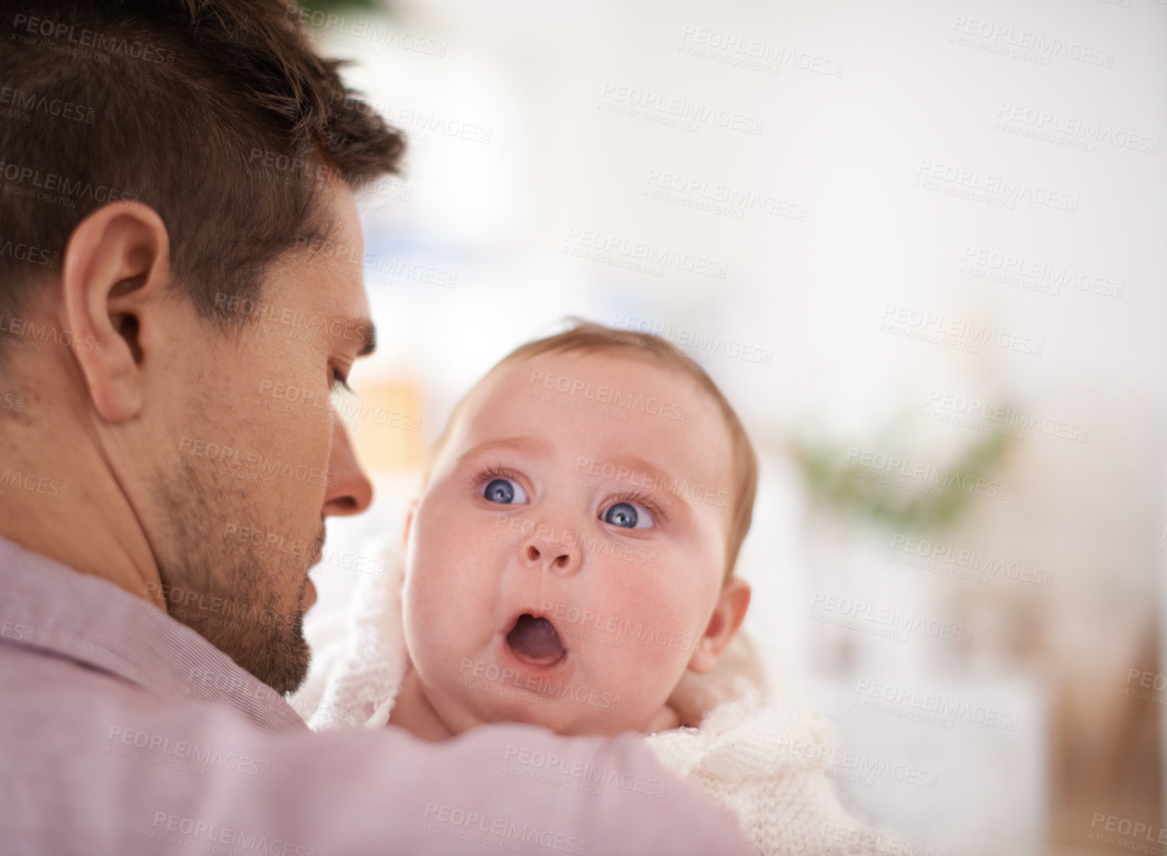 Buy stock photo A cute baby girl looking over her father's shoulder as he holds her