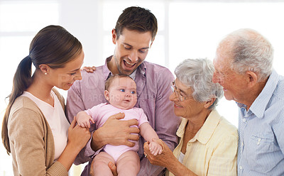 Buy stock photo Shot of a three-generational family adoring a baby girl