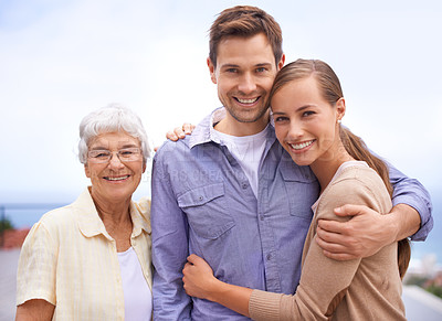 Buy stock photo Happy, family and portrait of mother with couple, husband and wife. Embrace and smiling with love and joy for senior woman at outdoor with bonding on a peaceful day for reunion and affection   