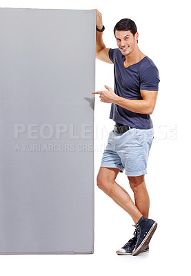Buy stock photo Man, pointing at mockup space and advertising signage, portrait with announcement or news on white background. Billboard, poster and sign with information, communication and about us promotion
