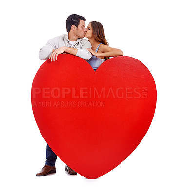 Buy stock photo Couple, kiss and heart paper in studio for romance, love and care with affection and mockup on a white background. Young woman and man with red poster, shape and marketing space for valentines day