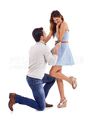 Buy stock photo Happy couple, man and woman engagement on a white background celebrate, love and smile in studio. Kneeling, proposal and commitment to marriage, happiness and romance in relationship with a ring
