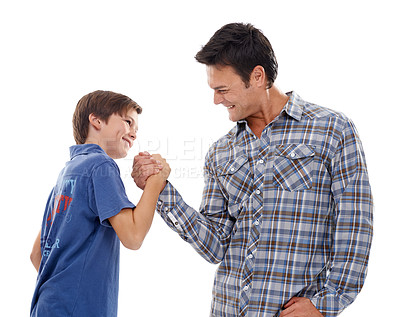Buy stock photo Father, arm wrestle and child with strength for game of power or playful bonding on a white studio background. Dad, son or kid with friendly handshake in battle for challenge, parenting or childhood