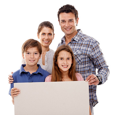 Buy stock photo Parents, kids and studio with blank poster in portrait with smile for bonding, love and space by white background. Mother, father and children with mockup, promotion or happy for family with security