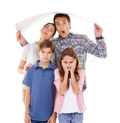 Buy stock photo Parents, children and studio with cardboard for roof, sign or portrait with funny face by white background. Mother, father and kids in family with safety, protection or security with insurance symbol