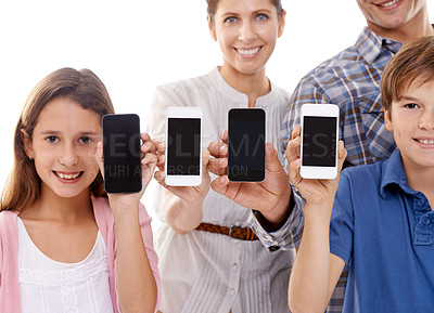 Buy stock photo Family, phone and display in studio with portrait for mockup space, advertising and marketing screen with smile. Father, mother and kids with smartphone, technology and happy face on white background