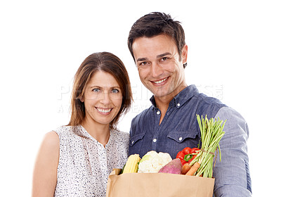 Buy stock photo Happy couple, portrait and shopping bag with groceries for food, natural sustainability or nutrition on a white studio background. Young man and woman with smile for healthy vegetables or ingredients