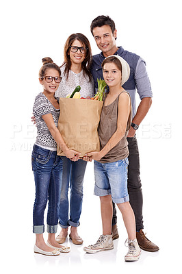 Buy stock photo A trendy family holding a bag of fresh produce together against a white background