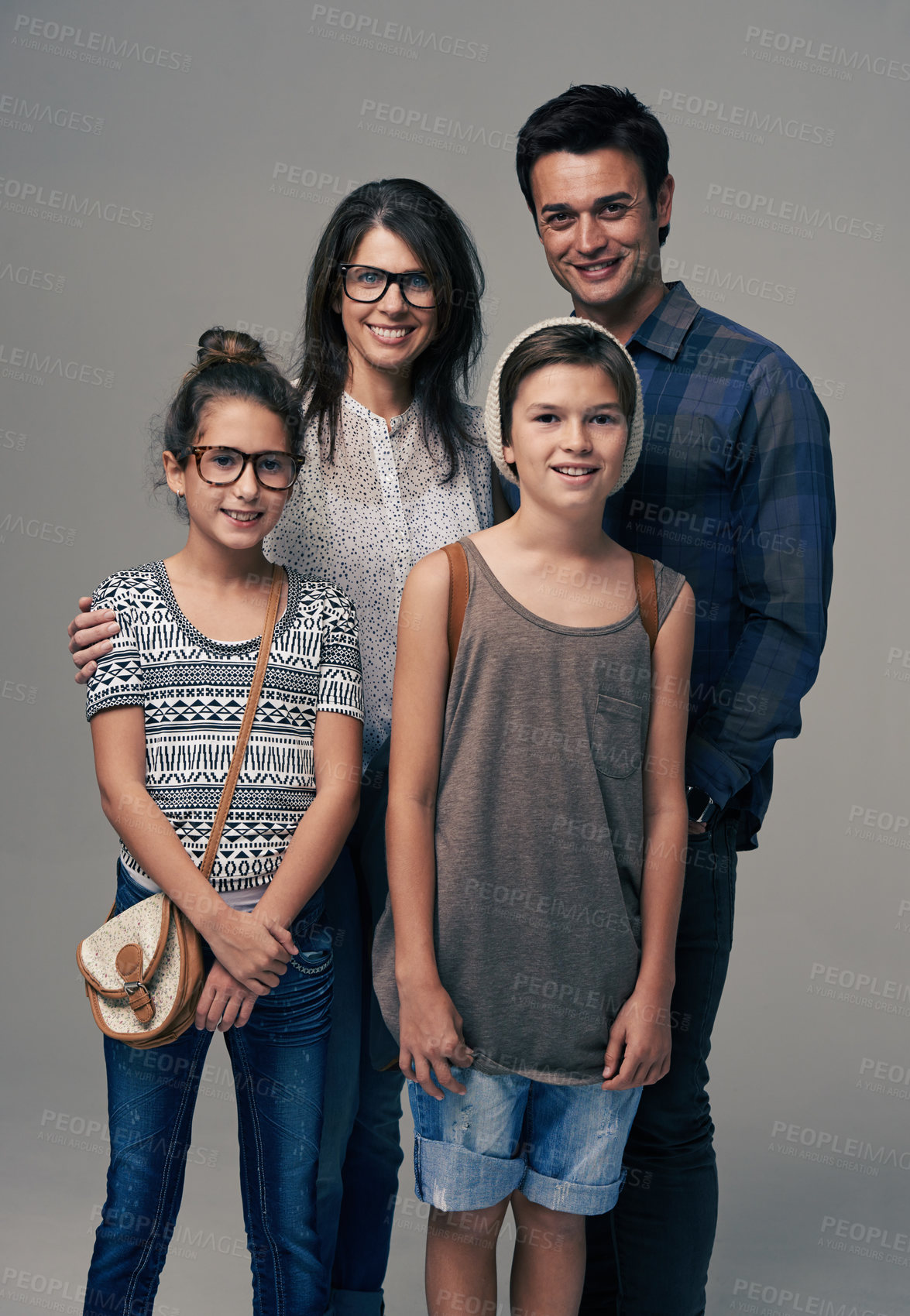 Buy stock photo Parents, kids and happy in studio portrait with pride, care and support with love by background. Mother, father and children with smile for family, kindness and clothes with trendy fashion for style