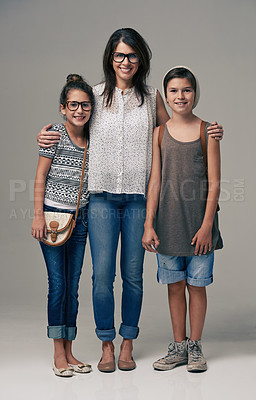 Buy stock photo Studio shot of a trendy mother posing with her son and daughter against a gray background