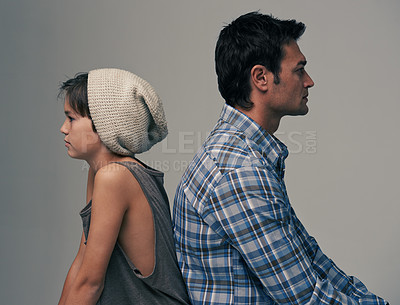 Buy stock photo Father, son and back in disagreement, argument or ignore with fashion on a gray studio background. Profile of dad, kid or young child in casual clothing, conflict or fight for parenthood or childhood