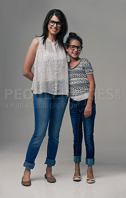 Buy stock photo Studio shot of a trendy mother and daughter against a gray background