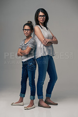Buy stock photo Studio shot of a trendy mother and daughter against a gray background