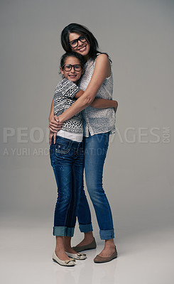 Buy stock photo Happy mother, portrait and hugging child with love for care or support in fashion on a gray studio background.  Mom, daughter or kid with smile in happiness for parenting or bonding on mockup space