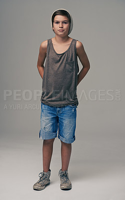Buy stock photo Young boy, portrait and fashion with denim shorts or jeans for style on a gray studio background. Male person, child or teenager with summer clothing or cool stylish outfit with beanie on mockup