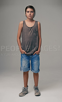 Buy stock photo Young boy, portrait and fashion with style in denim shorts or jeans on a gray studio background. Male person, child or teenager with summer clothing or cool stylish outfit with a beanie on mockup