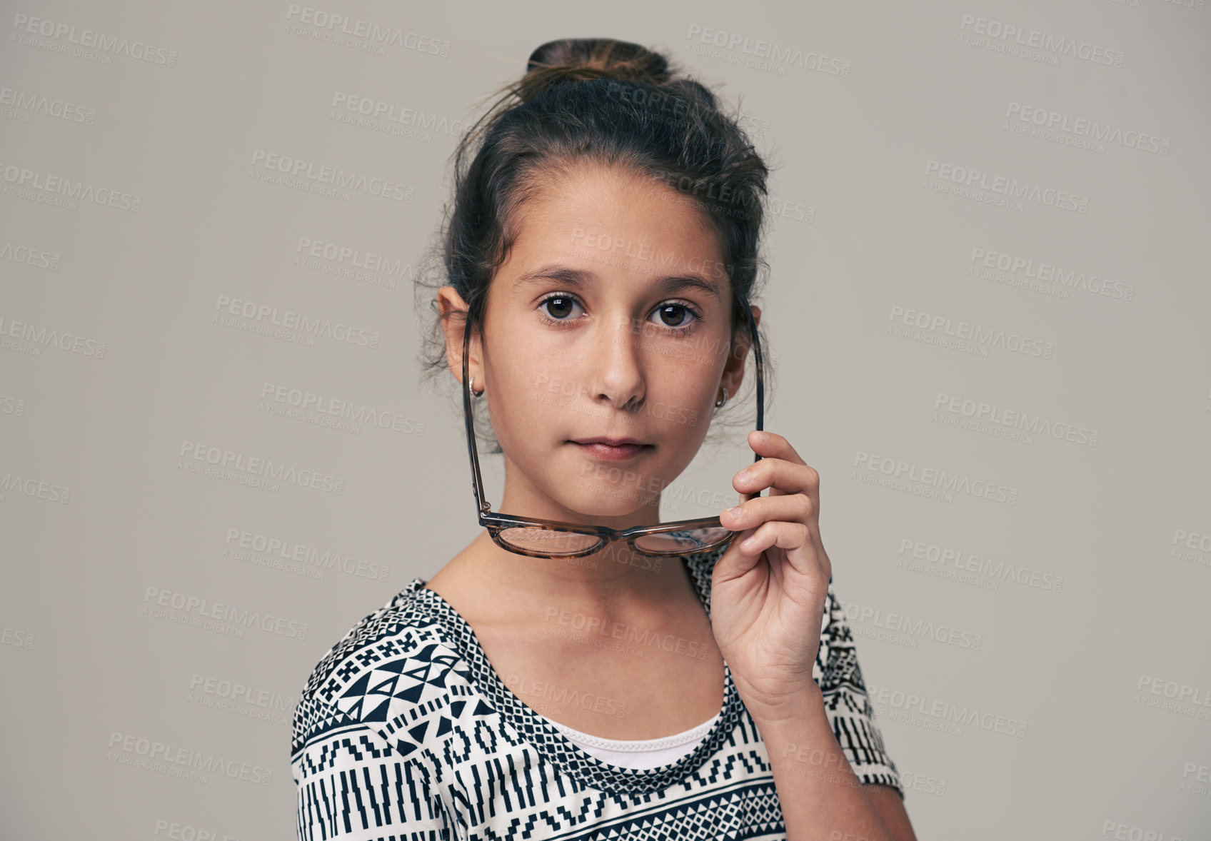 Buy stock photo Child, portrait and glasses in studio for eyesight vision with healthy optometry for wellness, grey background or lenses. Girl, face and frame spectacles at school kid. prescription or mockup space