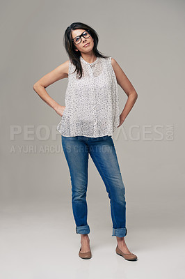 Buy stock photo Happy, woman and portrait for fashion style in denim jeans on a gray studio background. Female person, brunette or adult with casual clothing, glasses or stylish outfit in confidence on mockup space