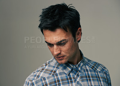 Buy stock photo Thinking, fashion and face of man on gray background with confidence, pride and serious. Looking down, wondering and isolated person with trendy clothes, casual outfit and style for studio closeup