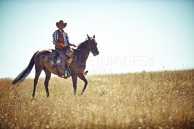 Buy stock photo Man, horse and countryside land as cowboy for adventure riding in Texas meadow for explore farm, exercise or training. Male person, animal and stallion in rural environment on saddle, ranch or hobby