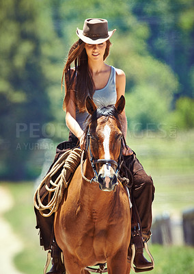 Buy stock photo Woman, cowgirl and horse riding in the countryside for journey, travel or outdoor adventure in nature. Female person or western rider with hat, saddle and animal stallion at ranch, farm or stable