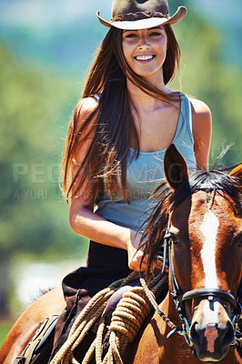 Buy stock photo Happy woman, countryside and portrait with cowgirl in horse riding for journey or outdoor adventure in nature. Female person or western rider with hat, saddle and animal stallion at ranch or farm