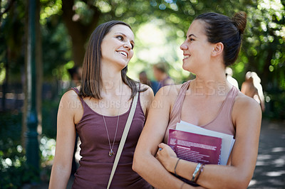 Buy stock photo Students, friends and talking of education on campus with learning, knowledge and books at college. Happy women with outdoor conversation in a park or university for scholarship, study or opportunity