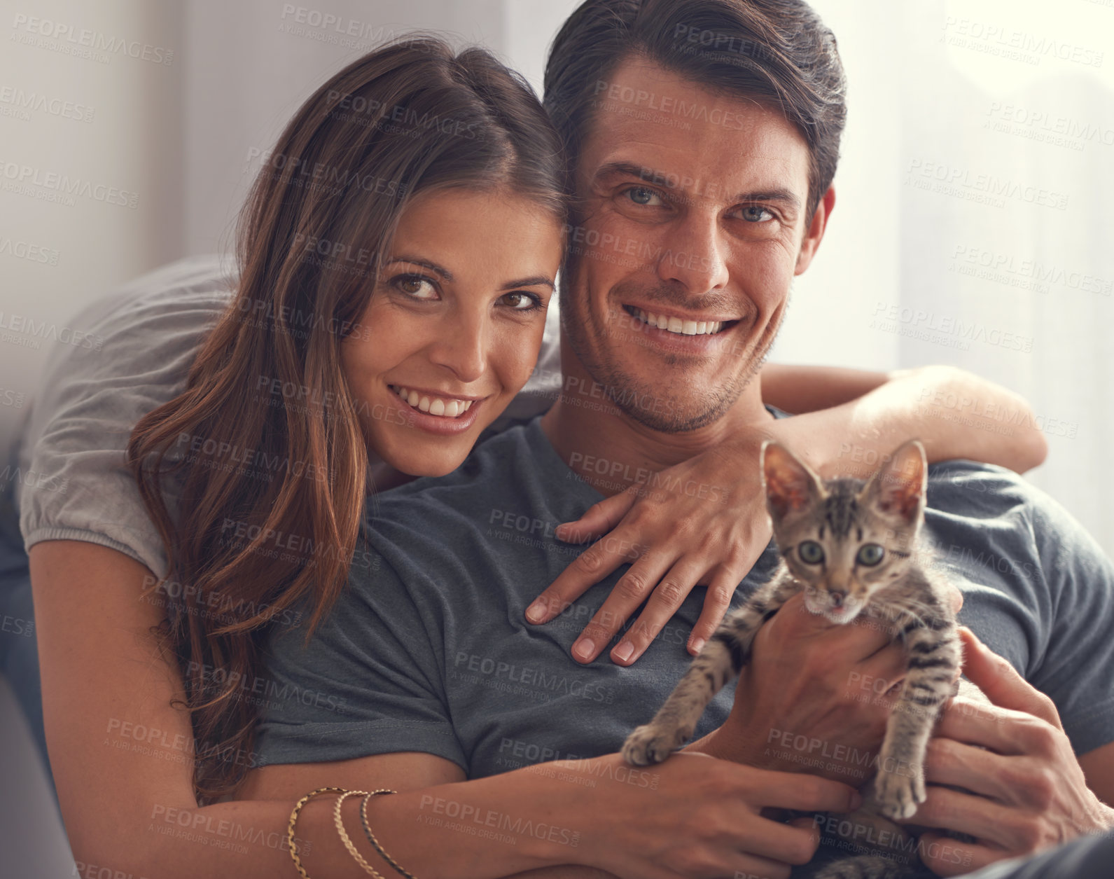 Buy stock photo Couple, kitten and portrait in home on sofa with hug for love, bonding or care for pet in living room. People, man and woman with kindness, embrace or pride for baby cat in lounge for animal adoption