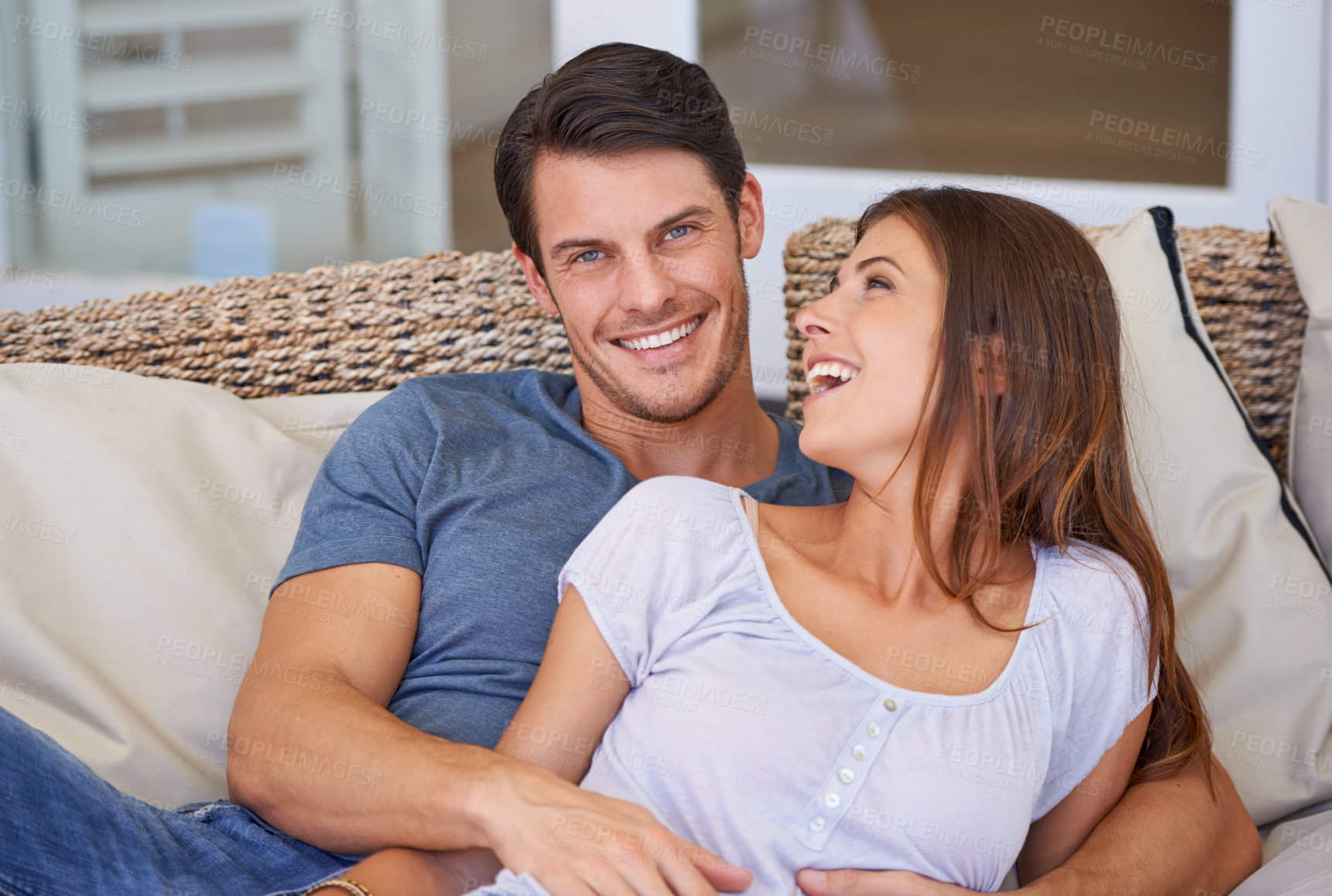 Buy stock photo Happy couple, smile and hug on sofa for holiday connection in Florida for bonding vacation, resting or marriage. Man, woman and embrace on comfortable couch for together commitment, love or safety