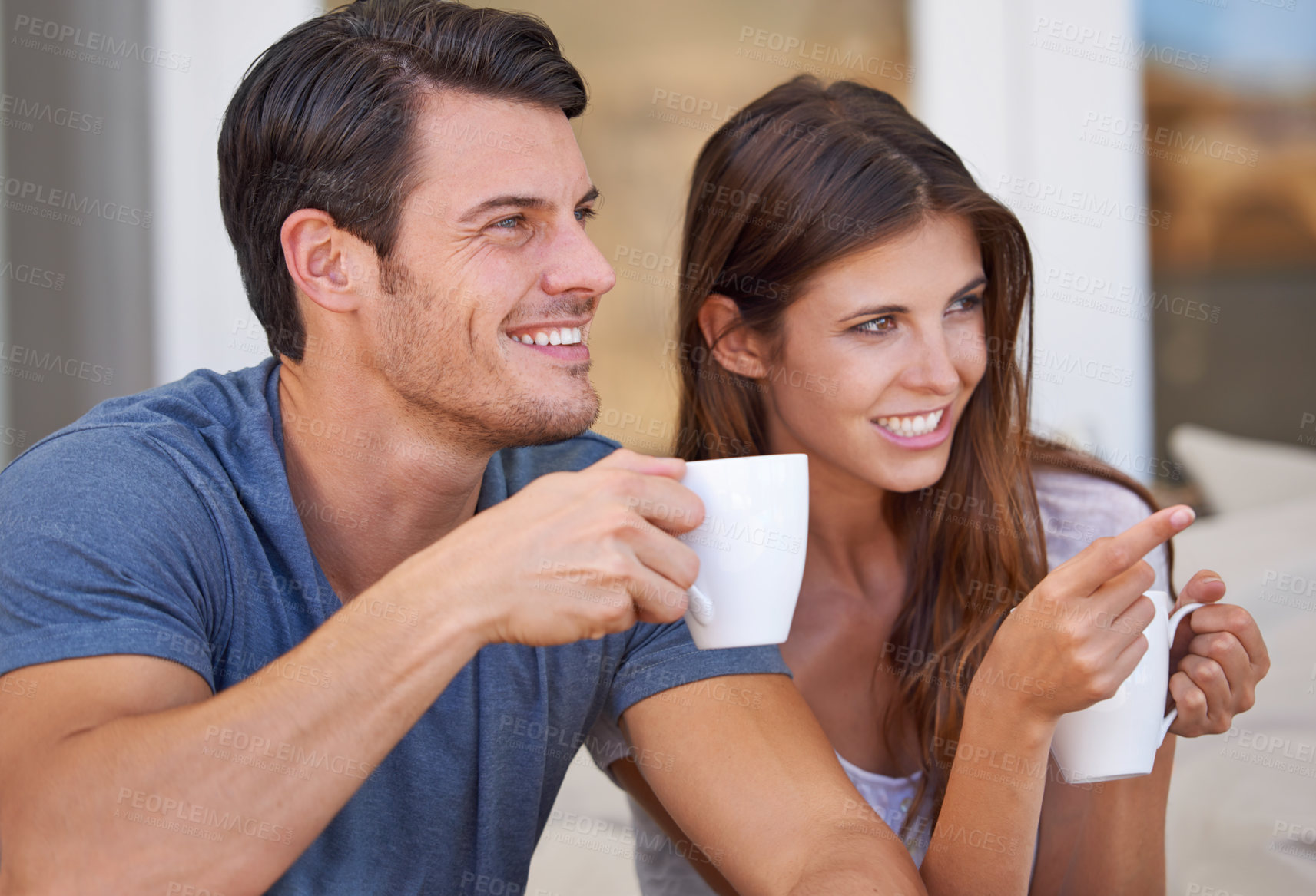 Buy stock photo Couple, watching tv and point with coffee on sofa for questions, conversation or choice in home. People, man and woman on lounge couch with streaming, movies and hug with drink in morning at house