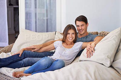 Buy stock photo Smile, portrait and couple relaxing on sofa for bonding in living room at apartment together. Happy, resting and young man and woman laying on couch for romance and marriage in lounge at modern home.