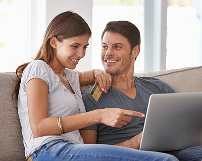 Buy stock photo Happy couple, pointing and laptop with credit card for online shopping, payment or purchase on sofa at home. Man and woman with smile or debit on computer for choice or order in ecommerce or banking