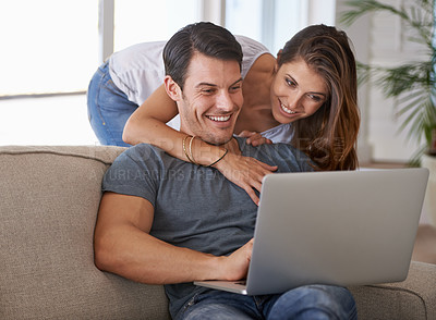 Buy stock photo Laptop, smile and woman hugging man on sofa networking on social media, website or internet. Happy, love and female person embracing husband reading online blog with computer in living room at home.