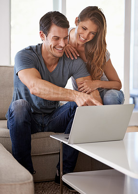Buy stock photo Couple, home and sofa with laptop, bonding and entertainment in living room with smile and laugh. Man, woman and couch with embrace, relax and love while pointing at tech in lounge at house 