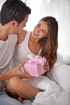 Buy stock photo Man giving woman gift, love and happy with partnership, relationship and celebration on Valentines day date. Couple smile with present, luxury and commitment, gratitude and celebrate holiday