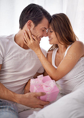 Buy stock photo Man giving woman gift box, love and smile with partner, relationship and celebration on Valentines day. Couple with present, forehead touch and luxury, commitment and gratitude, celebrate holiday