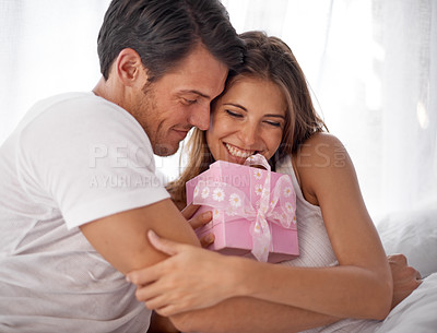 Buy stock photo Gift, hug and couple for valentines day love celebration with care and surprise in bedroom. Man and woman in happy home with box for birthday, holiday or luxury present with smile for gratitude
