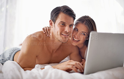 Buy stock photo Couple with laptop, streaming movie and relax at home with technology, happy and fun together with film website Love, commitment and relationship with man and woman in bedroom with subscription